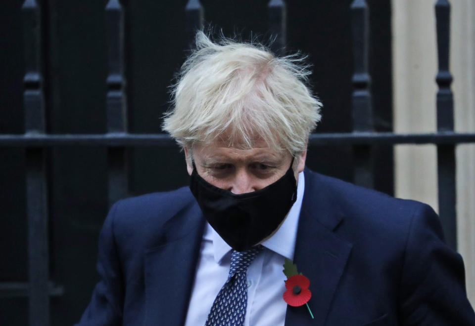 Britain's Prime Boris Johnson leaves 10 Downing Street to attend the weekly Prime Minister's Questions session in parliament in London, Wednesday, Nov. 4, 2020. (AP Photo/Frank Augstein)