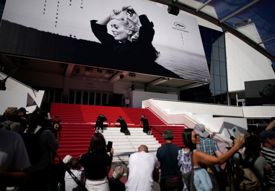 Workers roll out the red carpet for the 76th international film festival, Cannes, southern France, Tuesday, May 16, 2023. The Cannes film festival runs from May 16 until May 27 2023.