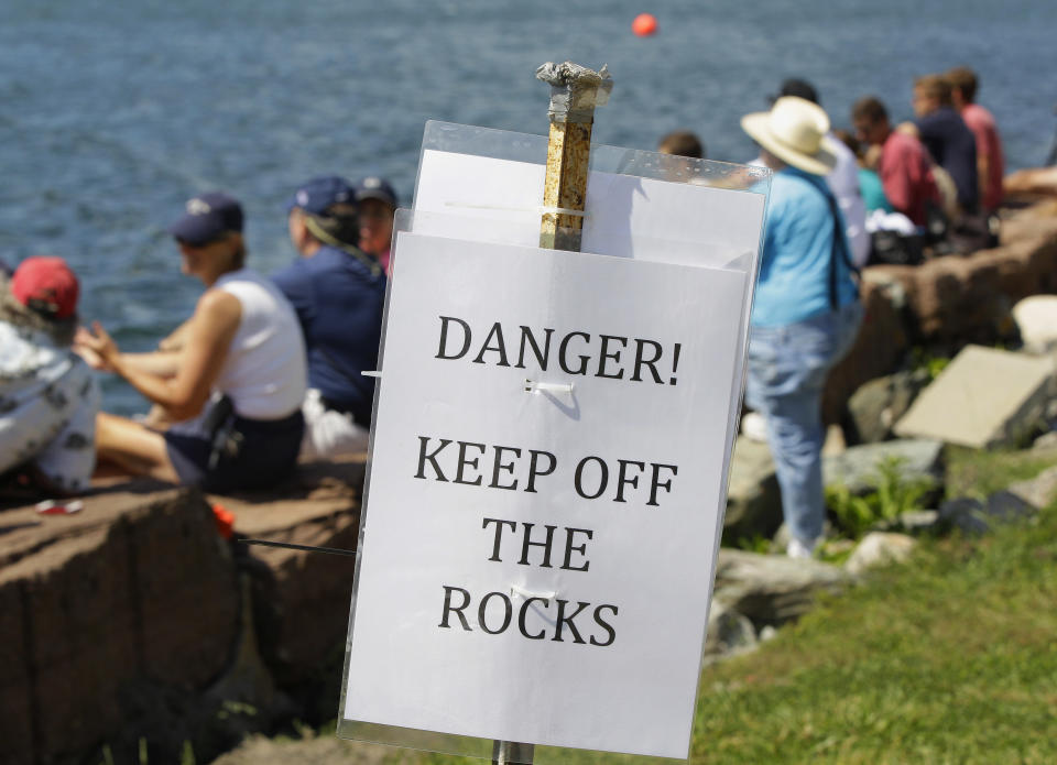 Spectators at Fort Adams State Park watch a match race at the first day of the America's Cup World Series regatta in Newport, RI., Thursday, June 28, 2012. State tourism officials say 7,400 people attended the first day of racing and hope 50,000 people in total will visit the nine-day event, which features four days of racing. (AP Photo/Stephan Savoia)