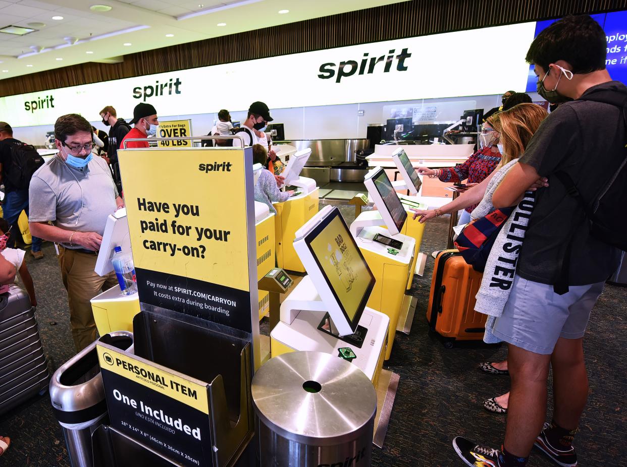 Travelers check in for a Spirit Airlines flight at Orlando International Airport in this file photo.