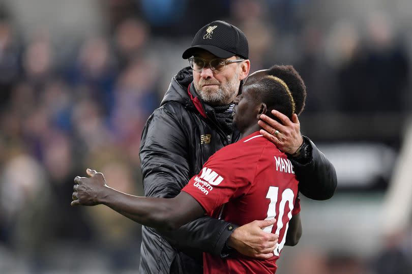 Jurgen Klopp embraces Sadio Mane after the Premier League match between Newcastle United and Liverpool FC at St James' Park on May 04, 2019