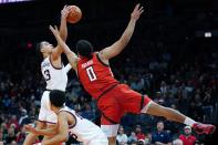 Texas Tech forward Kevin Obanor (0) and Gonzaga guard Andrew Nembhard (3) battle for a loose ball as Gonzaga forward Colby Brooks, front left, looks on during the second half of an NCAA college basketball game at the Jerry Colangelo Classic Saturday, Dec. 18, 2021, in Phoenix. Gonzaga won 69-55. (AP Photo/Ross D. Franklin)