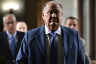 Former FirstEnergy CEO Charles Jones walks toward the courtroom at the Summit County courthouse in Akron, Ohio on Tuesday, Feb. 13, 2024. Two fired executives of FirstEnergy Corp. and a former top state utilities regulator pleaded not guilty Tuesday to state charges related to a $60 million bribery scheme that centered on securing a legislative bailout for two Ohio nuclear power plants with the help of a powerful House speaker. (AP Photo/David Dermer)