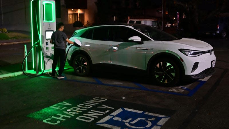 A driver charges his electric vehicle at a charging station as the California Independent System Operator announced a statewide electricity Flex Alert urging conservation to avoid blackouts in Monterey Park, California on August 31, 2022.