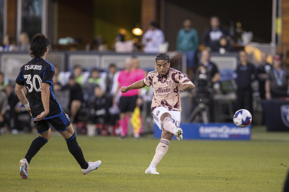 Portland Timbers midfielder Evander shoots past San Jose Earthquakes midfielder Niko Tsakiris (30) during the first half of an MLS soccer match in San Jose, Calif., Saturday, June 17, 2023. (AP Photo/John Hefti)