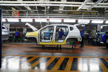 Employees work on Baojun RS-5 cars at a final assembly plant operated by General Motors Co and its local joint-venture partners in Liuzhou, Guangxi Zhuang Autonomous Region, China, February 28, 2019. REUTERS/Aly Song