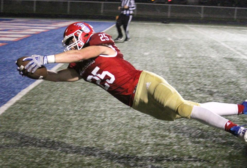 Martinsville sophomore Brayden Shrake dives across the goal line during Friday's IHSAA Class 4A Sectional semi-final game at home against South Dearborn.