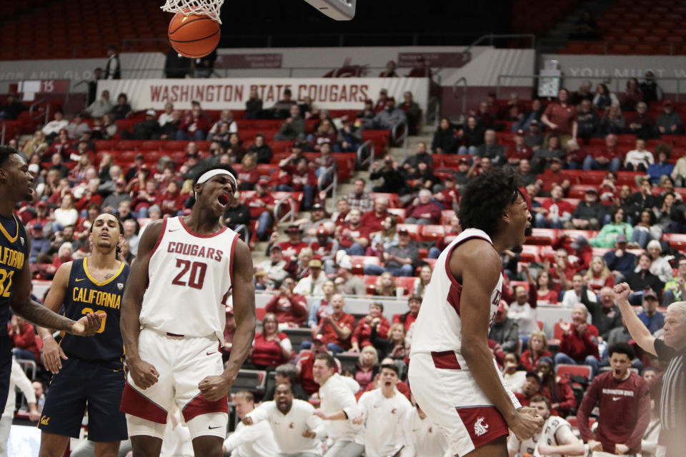 Washington State forward Isaac Jones, right, celebrates his basket next to teammate Rueben Chinyelu (20) during the second half of an NCAA college basketball game against California, Thursday, Feb. 15, 2024, in Pullman, Wash. (AP Photo/Young Kwak)