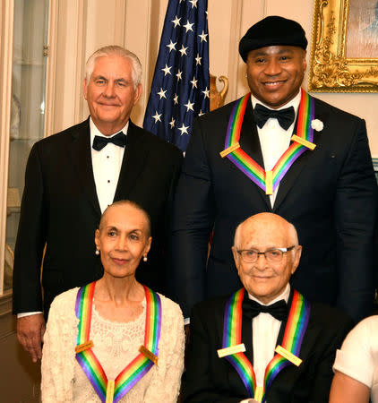 U.S. Secretary of State Rex Tillerson (L, standing) poses with 2017 Kennedy Center Honorees Rapper LL Cool J (R, standing) and (seated L-R) dancer, actress and choreographer Carmen de Lavallade and TV writer Norman Lear, for a group photo at the conclusion of a gala dinner at the U.S. State Department, in Washington, U.S., December 2, 2017. REUTERS/Mike Theiler