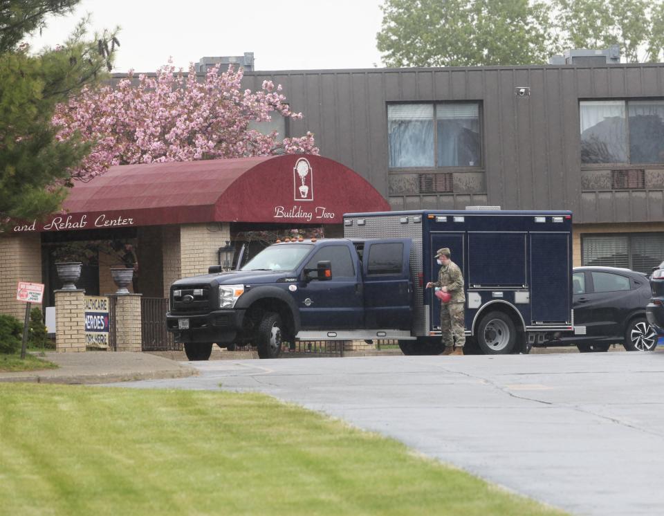 A soldier with the National Guard is seen in front of the entrance to the Andover Subacute and Rehabilitation II building on May 8.