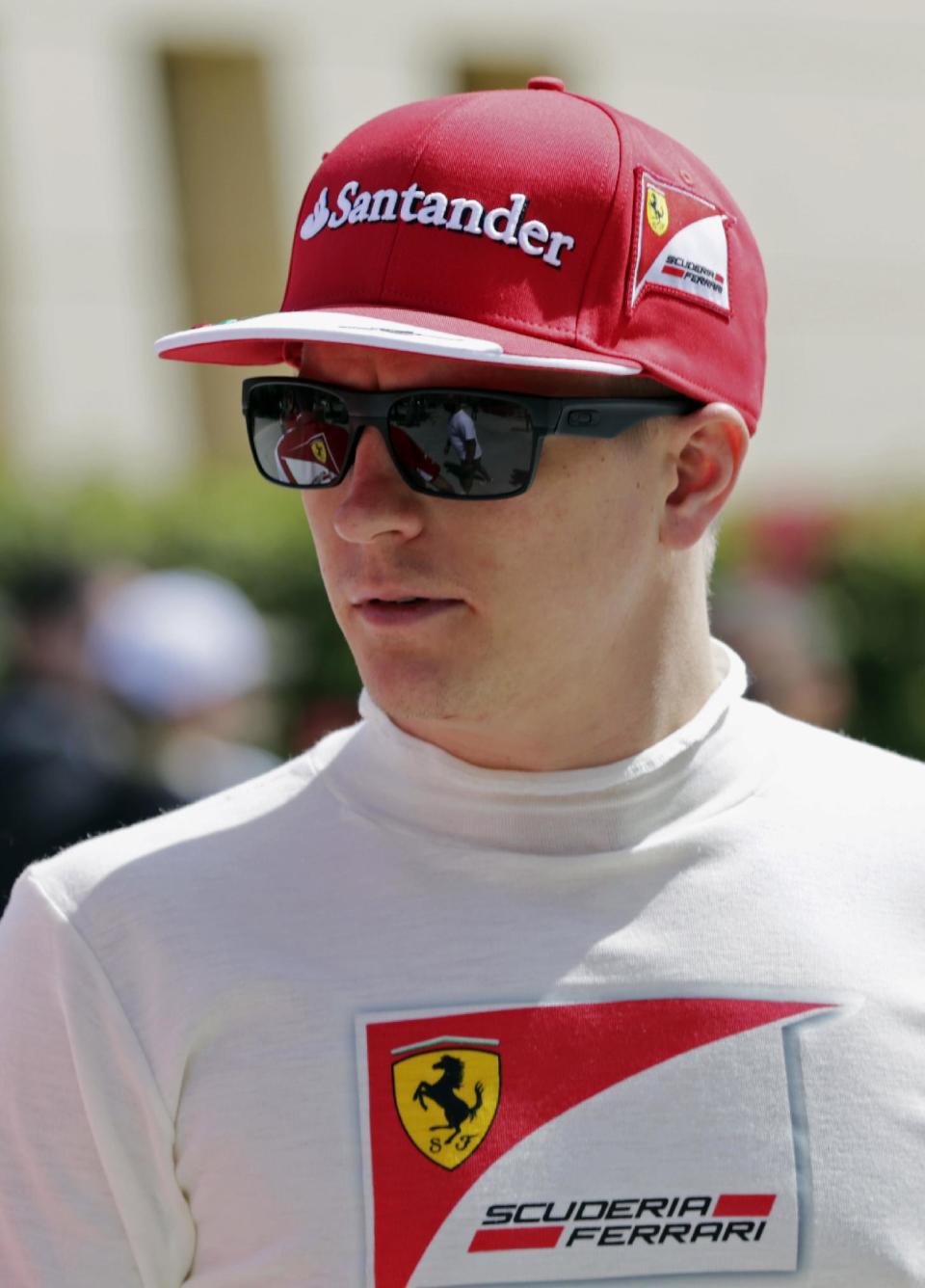 Formula One driver Kimi Raikkonen of Ferrari walks in the paddock during pre-season testing at the Bahrain International Circuit in Sakhir, Bahrain, Saturday, March 1, 2014. (AP Photo/Hasan Jamali)