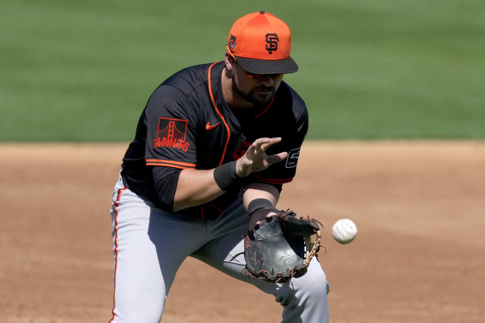 San Francisco Giants' J.D. Davis fields a ground out hit by Oakland Athletics' Esteury Ruiz during the second inning of a spring training baseball game, Wednesday, Feb. 28, 2024, in Mesa, Ariz. (AP Photo/Matt York)