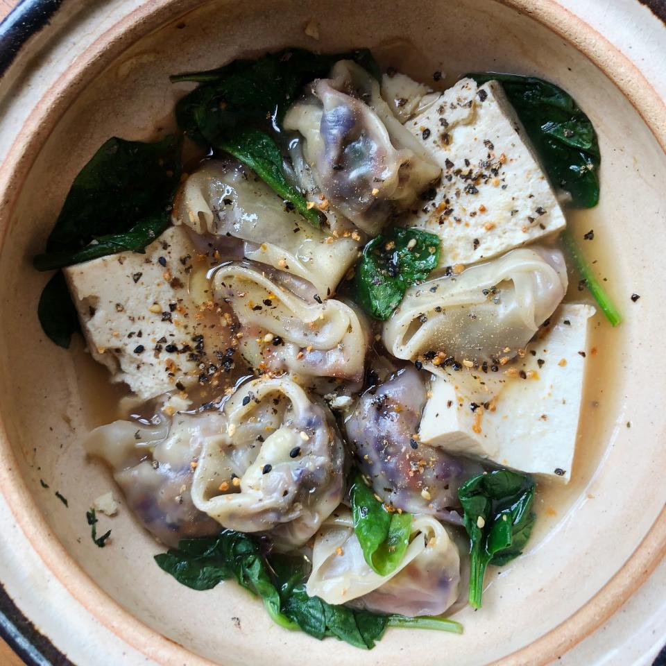 Homemade dumplings in dashi with spinach, shichimi togarashi, and tofu.