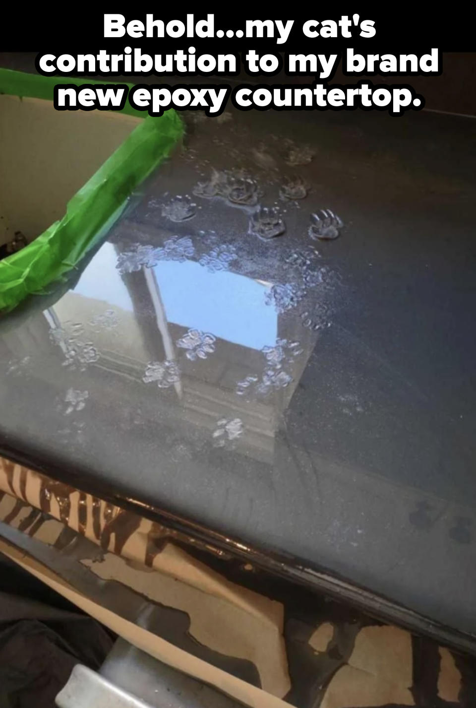 Car window covered with frost patterns, partially scraped clean. Tape visible on top