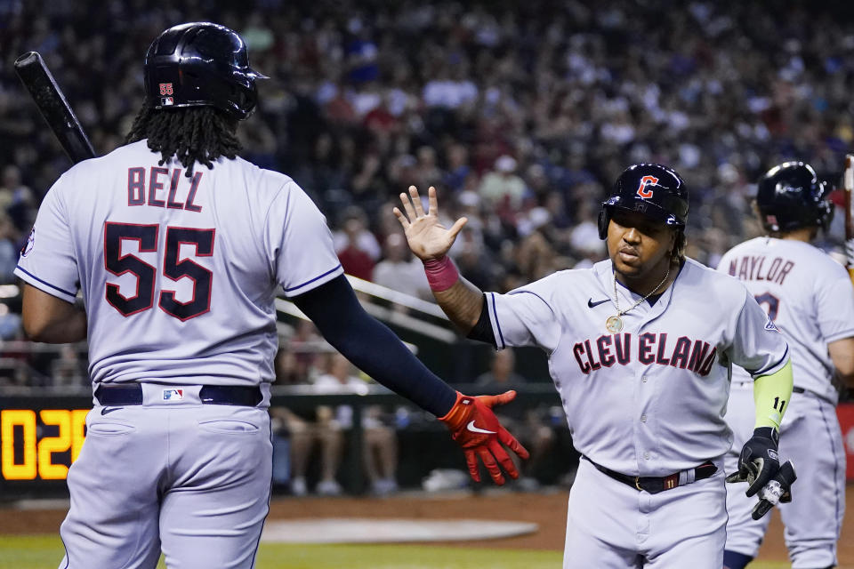 Cleveland Guardians' Jose Ramirez, right, celebrates his home run against the Arizona Diamondbacks with Josh Bell (55) during the fourth inning of a baseball game Friday, June 16, 2023, in Phoenix. (AP Photo/Ross D. Franklin)