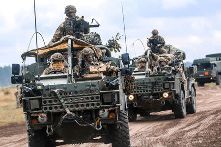 FILE PHOTO: A convoy Jackal vehicles with the British Army's 1st The Queen's Dragoon Guards move to begin a multinational training event for exercise Puma 2 with Battle Group Poland at Bemowo Piskie Training Area, Poland June 14, 2018. U.S. Army/Spc. Hubert D. Delany III/22nd Mobile Public Affairs Detachment/Handout via REUTERS.