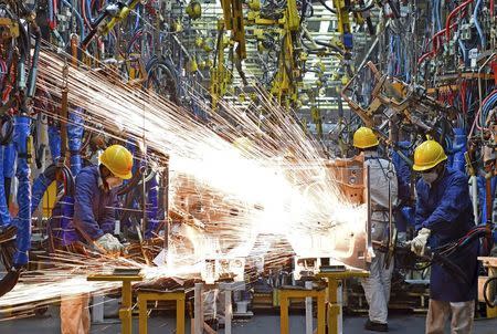 Employees work along a production line at a factory of Dongfeng Nissan Passenger Vehicle Co. in Zhengzhou, Henan province, China, November 12, 2015. REUTERS/Stringer