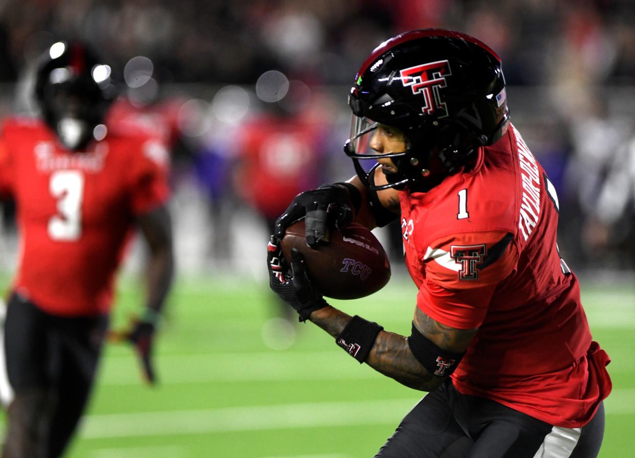 Texas Tech's defensive back Dadrion Taylor-Demerson (1) intercepts the ball against TCU in a Big 12 football game, Thursday, Nov. 2, 2023, at Jones AT&T Stadium.