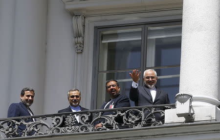 Iranian Foreign Minister Javad Zarif (R) listens to questions from journalists as he stands next to Iran's chief nuclear negotiator Abbas Araghchi (L) and Hossein Fereydoon (2nd L), brother and close aide to President Hassan Rouhani, on the balcony of Palais Coburg, the venue for nuclear talks in Vienna, Austria, July 10, 2015. REUTERS/Leonhard Foeger