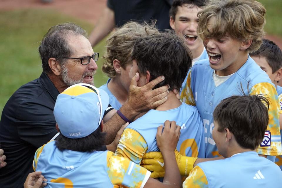 Young ball players gather close in a group.