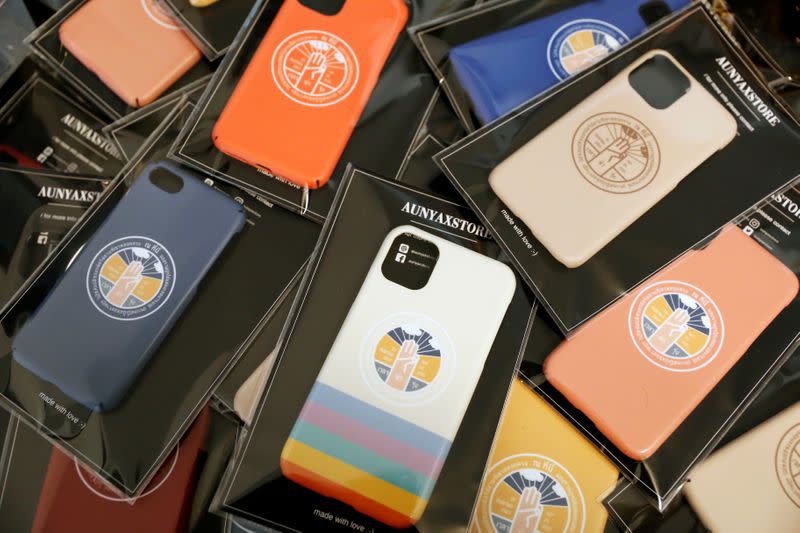 Phone cases printed with a plaque declaring "This country belongs to the people" are seen at a shop in Nonthaburi province