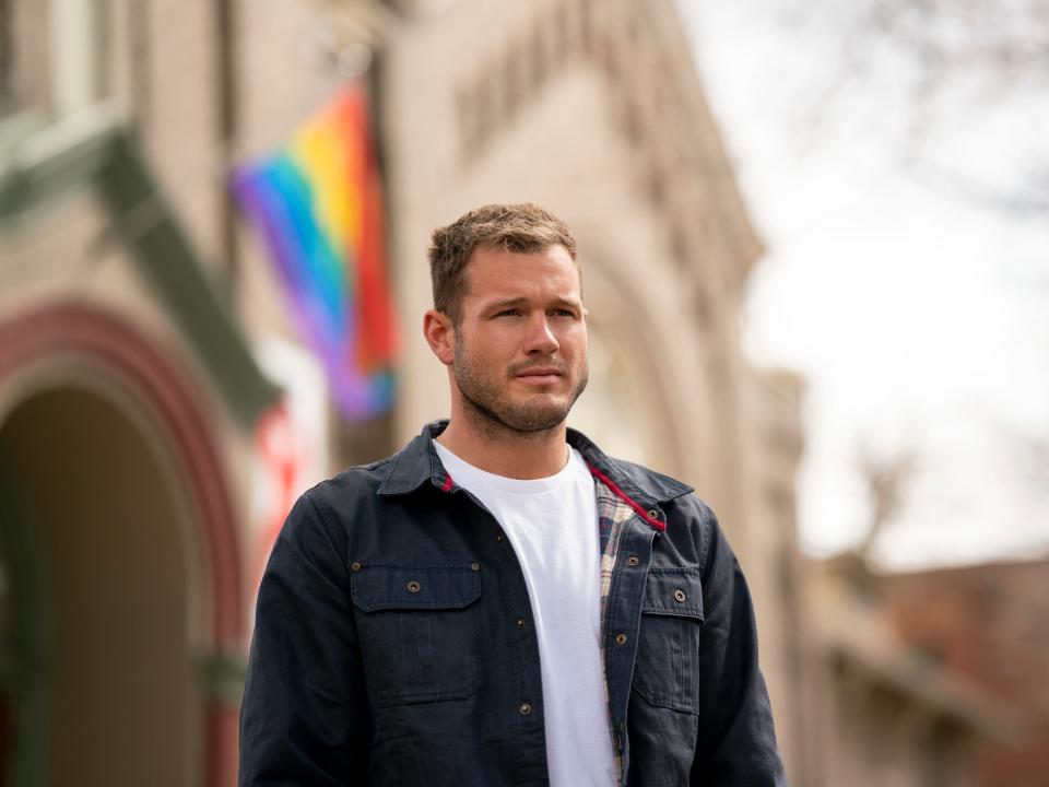 screengrab of colton standing in front of a pride flag on coming out colton