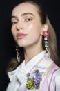 <p>The hair at Badgley Mischka was slicked-back only to behind the ears, serving as the perfect frame for statement earrings.</p>