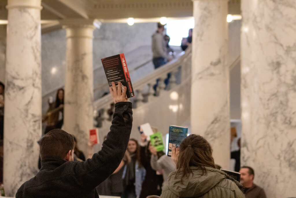 Attendees hold books in support of Idaho libraries at the "Idaho Freedom to Read-in" event held at the Idaho Capitol Building