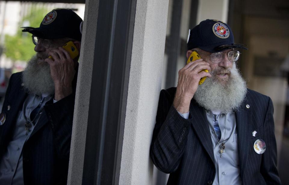 Keith Maupin talks with reporters on his cell phone about his son, Sgt. Matt Maupin, in Arlington, Va.,Tuesday, May 13, 2014. A man in Iraqi custody has confessed to killing Sgt. Matt Maupin whose remains were found in 2008. Sgt. Matt Maupin, of Batavia in southwestern Ohio, was captured when insurgents with rocket-propelled grenades and small arms ambushed his fuel convoy near Baghdad on April 9, 2004. Keith Maupin decided to grow his beard until his son came home. He has never cut it. (AP Photo)