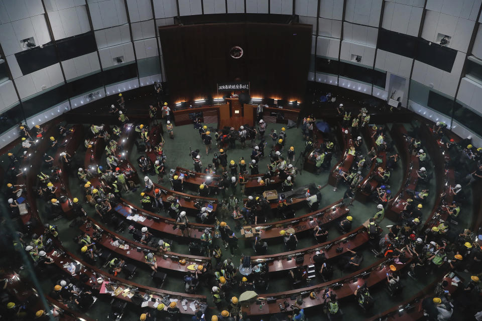FILE - Protesters gather inside the meeting hall after breaking in to the Legislative Council in Hong Kong on July 1, 2019. A Hong Kong court on Thursday, Feb. 1, 2024, convicted four people for rioting over the storming of the city's legislative council building at the height of the anti-government protests more than four years ago. (AP Photo/Kin Cheung, File)
