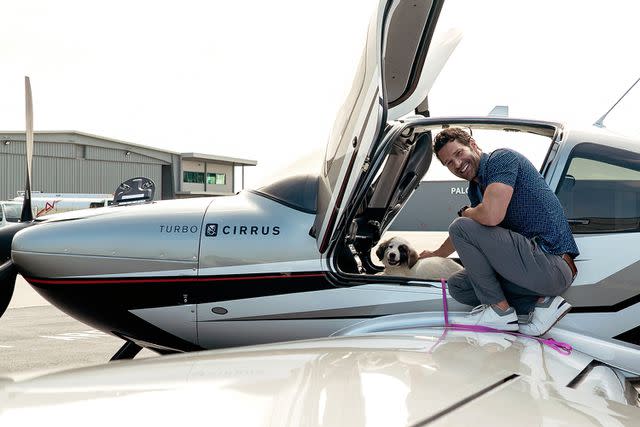 <p>Cirrus</p> Aaron O'Connell helping Patches the puppy get acclimated to his aircraft