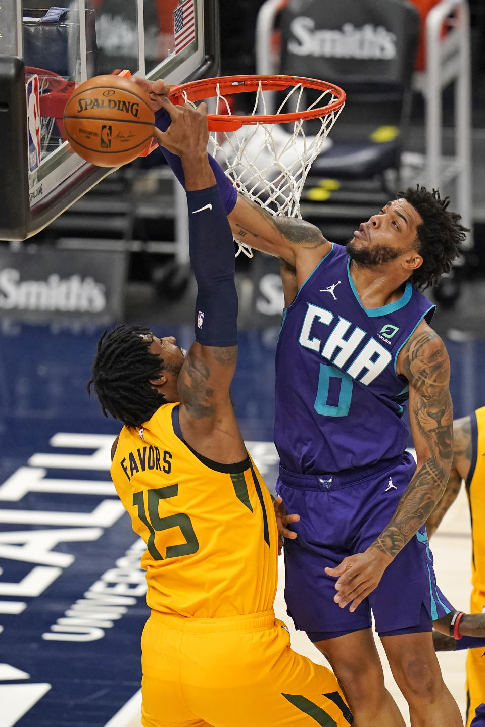 Charlotte Hornets forward Miles Bridges (0) blocks the shot from Utah Jazz center Derrick Favors (15) in the first half during an NBA basketball game Monday, Feb. 22, 2021, in Salt Lake City. (AP Photo/Rick Bowmer)