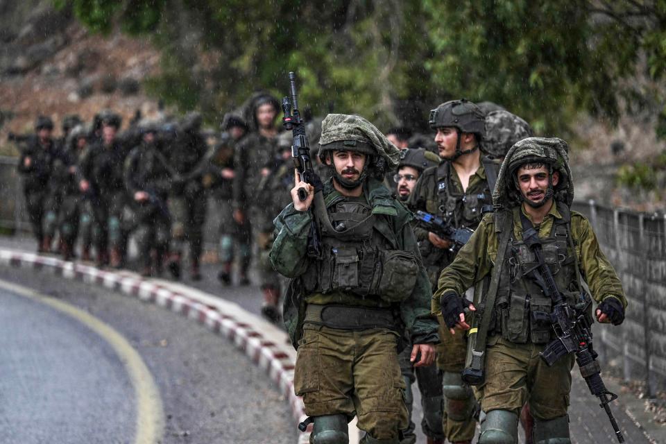 Israeli army soldiers patrol an undisclosed area in northern Israel bordering Lebanon on October 15, 2023, amid the ongoing battles between Israel and the Palestinian Islamist group Hamas. Lebanon's Hezbollah and Israel exchanged deadly border fire on October 15, with the Iran-backed group claiming responsibility for strikes that Israel said killed a civilian, further raising cross-border tensions during Israel's war with Gaza-based militants.