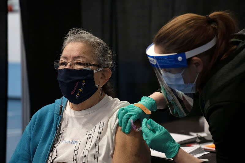 People from rural communities get their coronavirus disease (COVID-19) vaccinations at Menominee Indian High School in Menominee, Wisconsin