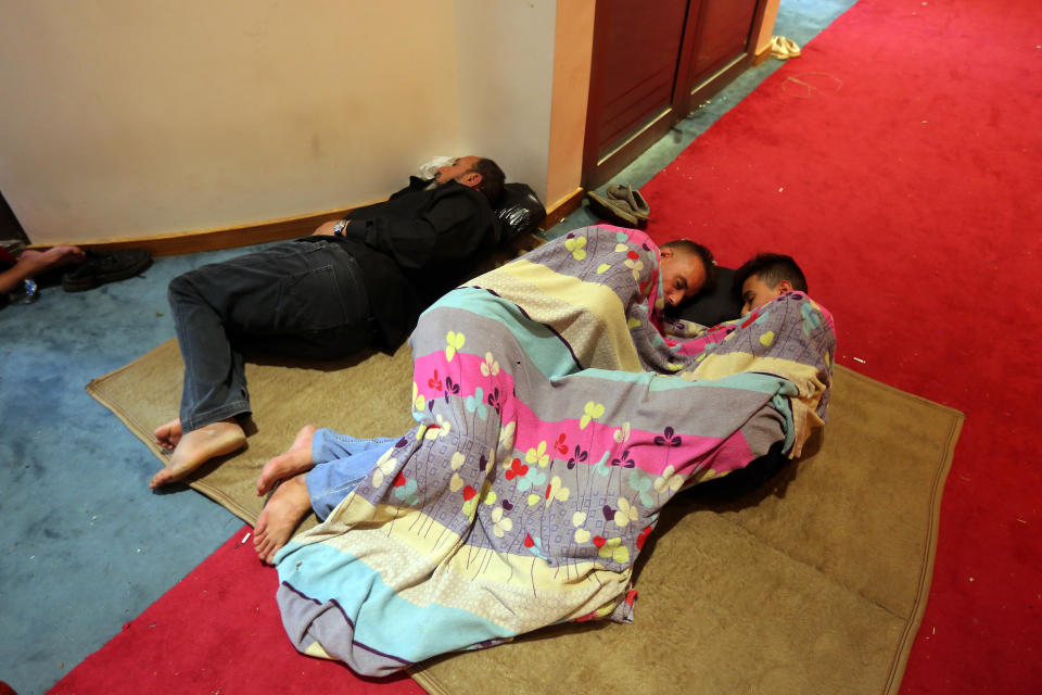 Iraqi protesters rest inside the Parliament building in Baghdad, Iraq, Sunday, July 31, 2022. Thousands of followers of an influential Shiite cleric stormed into Iraq's parliament on Saturday, for the second time this week, protesting government formation efforts led by his rivals, an alliance of Iran-backed groups. (AP Photo/Anmar Khalil)