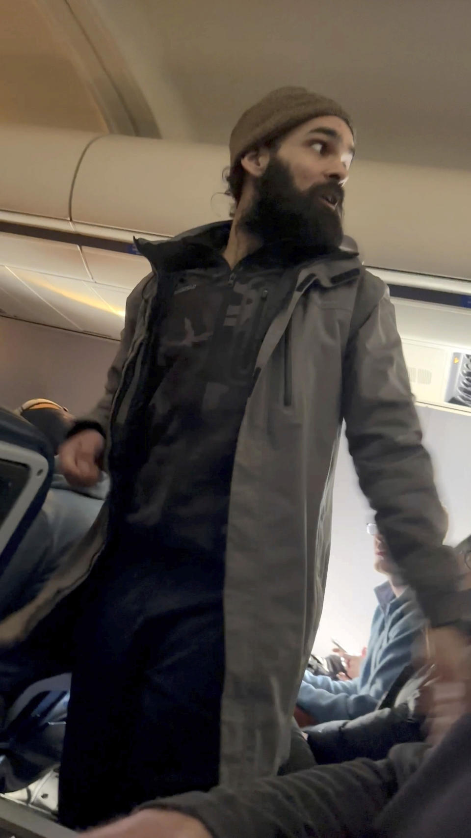 FILE - This still image from video provided by Lisa Olsen shows a man who federal authorities have identified as Francisco Severo Torres as he moves through the cabin on a weekend flight from Los Angeles to Boston, March 5, 2023. The Massachusetts man accused of attacking a flight attendant and attempting to open the plane's emergency door on a cross-country flight has directed attention to passengers with mental health challenges. (Lisa Olsen via AP, File)