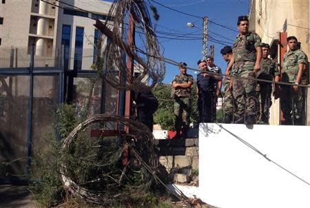 Lebanese army soldiers and policemen secure an area as they close a road leading to the U.S. embassy with barbed wire and barricades, ahead of a protest against potential U.S. strikes on Syria, in Awkar, north of Beirut, September 6, 2013. U.S. officials ordered non-emergency personnel and their family members out of Lebanon on Friday "due to threats," the U.S. embassy in Beirut said in statement. REUTERS/Mohamed Azakir