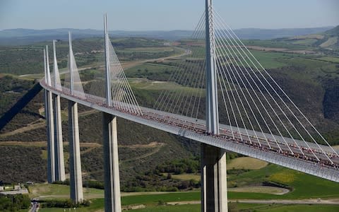 Runners compete in a race across France's Millau Viaduct - Credit: GETTY