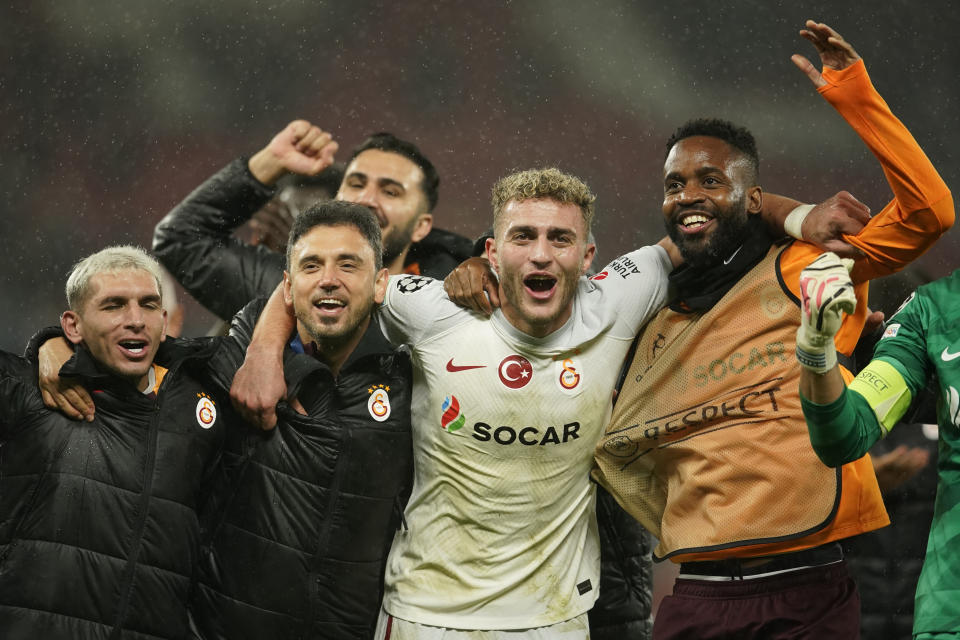 Galatasaray's players celebrate after winning the Champions League group A soccer match between Manchester United and Galatasaray at the Old Trafford stadium in Manchester, England, Tuesday, Oct. 3, 2023. Galatasaray won 3-2. (AP Photo/Dave Thompson)