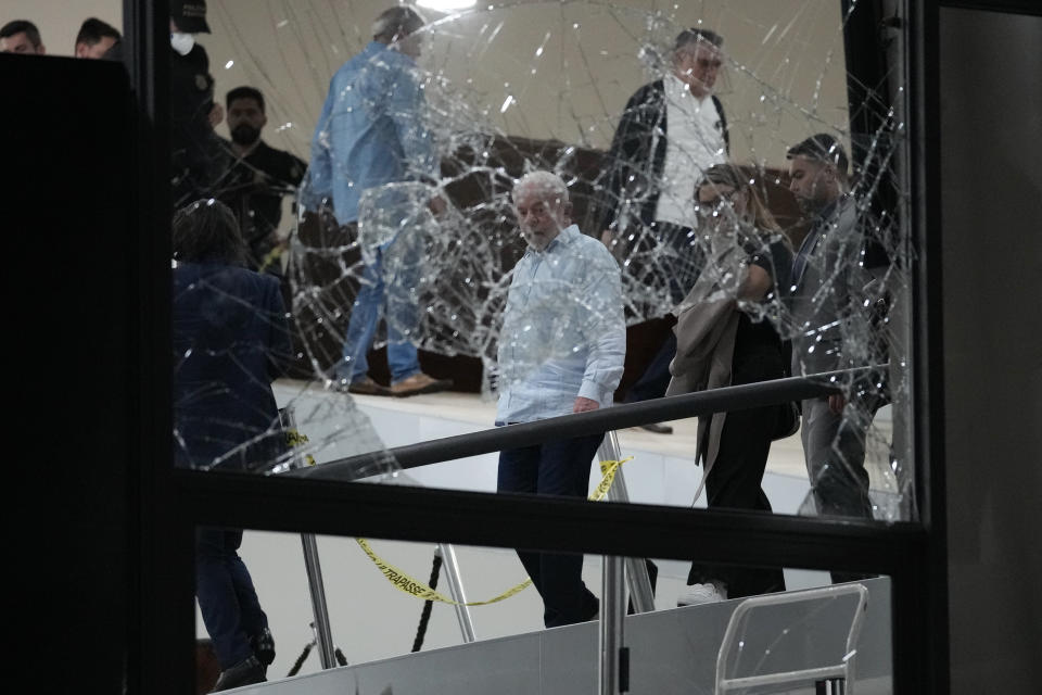 FILE - Brazil's President Luiz Inacio Lula da Silva walks in Planalto Palace after it was stormed by supporters of Brazil's former President Jair Bolsonaro in Brasilia, Brazil, Jan. 8, 2023. Videos from the mayhem showed soldiers standing by as invaders broke windows, defecated in government offices and destroyed valuable artworks. (AP Photo/Eraldo Peres, File)