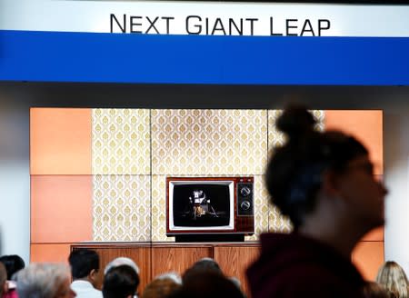 People watch footage on a mock-up of a 1960s television at the exact 50th anniversary of the Apollo 11 moon landing at the Charles Simonyi Space Gallery at the Museum of Flight in Seattle