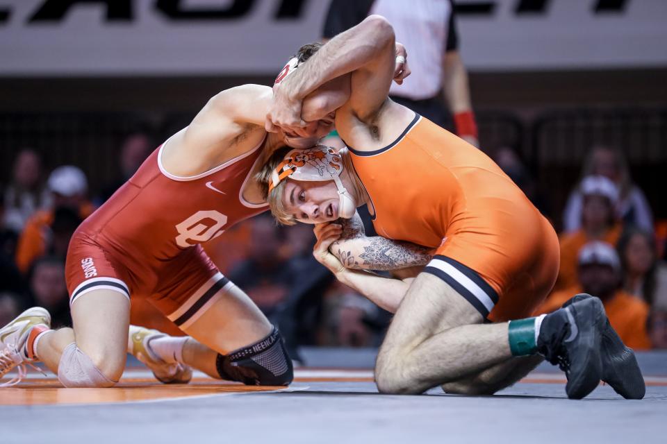 Oklahoma State's Carter Young, right, won one of the most important matches of Thursday night's Bedlam wrestling dual, defeating Mosha Schwartz at 141 pounds.