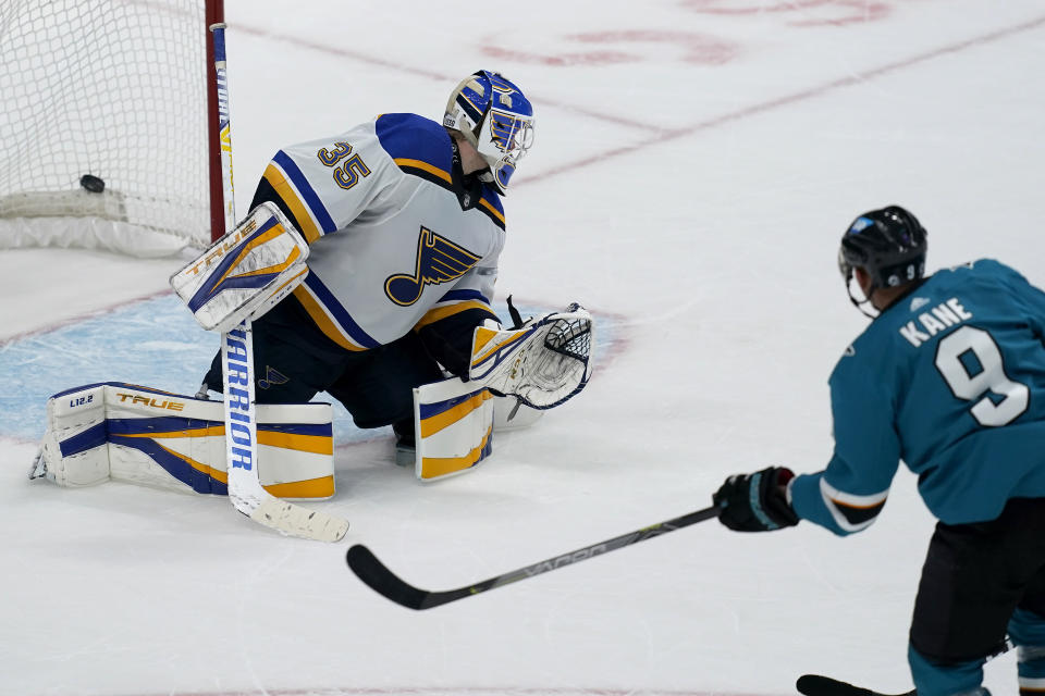 San Jose Sharks left wing Evander Kane (9) scores past St. Louis Blues goaltender Ville Husso (35) during overtime of an NHL hockey game in San Jose, Calif., Monday, March 8, 2021. (AP Photo/Jeff Chiu)