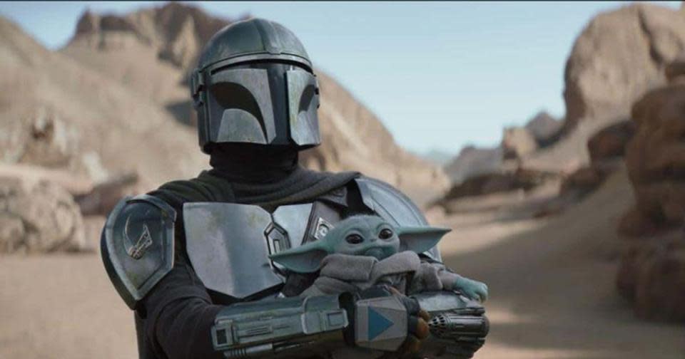 Din Djarin holding Grogu in The Mandalorian Season 3