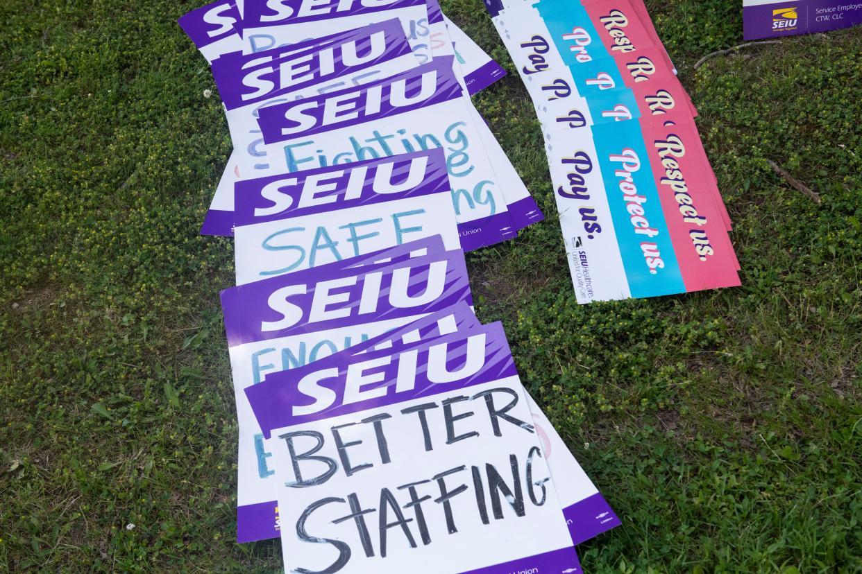 Signs lay on the grass outside of the Beaver Valley Healthcare and Rehab Center in 2021 before a proposed strike, wich was averted by a contract agreement.