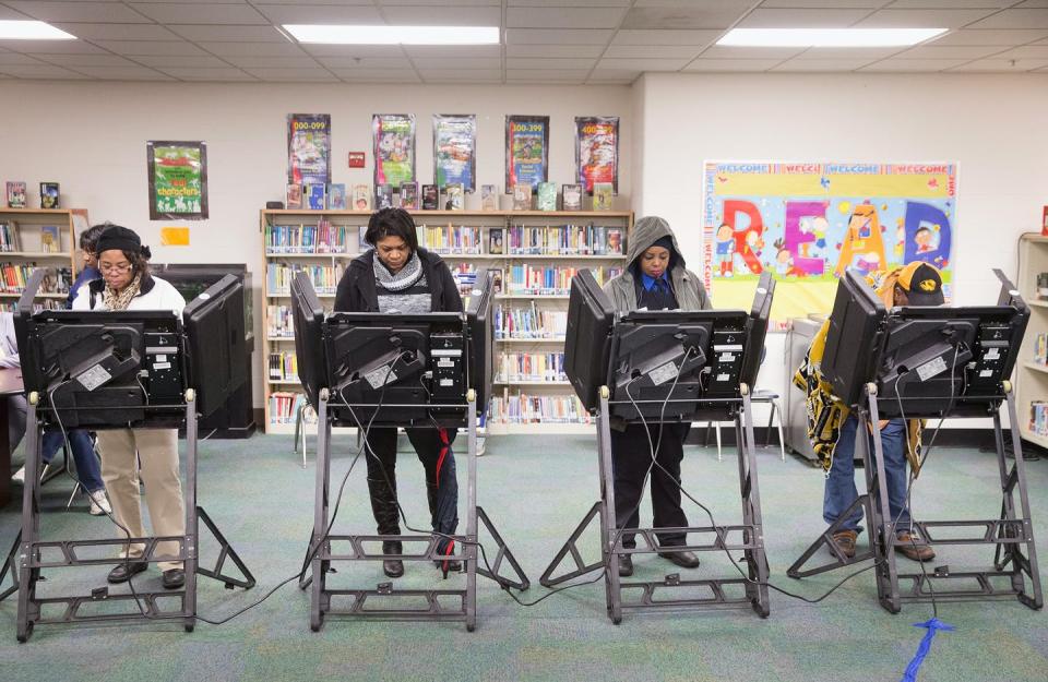 Four voters who are Black casting ballots.