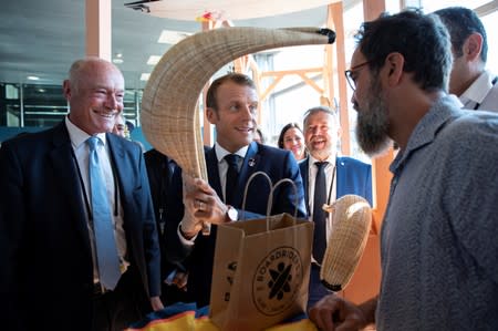 French President Macron tours the exhibition hall above the international press center on the opening day of the G7 summit, in Anglet