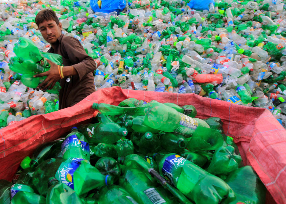 A worker sorts plastic bottles at a recycling workshop in Islamabad, Pakistan.&nbsp; (Photo: Caren Firouz / Reuters)