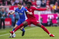 Cologne's Faride Alidou, right, and Darmstadt's Matthias Bader fight for the ball during the German Bundesliga soccer match between Darmstadt and FC Cologne at the RheinEnergieStadion in Cologne, Germany, Saturday April 20, 2024. (Marius Becker/dpa via AP)