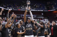 FILE - Las Vegas Aces' A'ja Wilson holds up the championship trophy as she celebrates with teammates after their win in the WNBA basketball finals against the Connecticut Sun, Sept. 18, 2022, in Uncasville, Conn. The Vegas Golden Knights' Stanley Cup championship is the latest big step for a city that didn't have major professional sports less than a decade ago. (AP Photo/Jessica Hill, File)